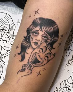 a woman holding a baby tattoo on her leg