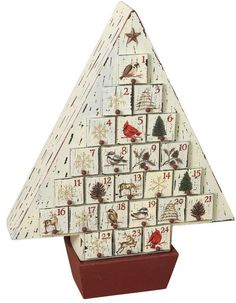 a christmas tree made out of wooden blocks with pictures on it's sides and numbers in the middle