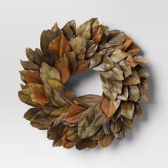 a close up of a wreath made out of leaves on a white background with no people around it