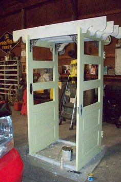 an open door in the middle of a garage with tools and other items on it