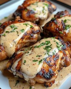 grilled chicken with gravy on a white plate