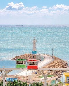 a light house sitting on top of a pier next to the ocean