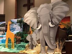 an elephant and two giraffes are on display