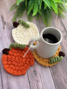 two crocheted coasters sitting next to each other on top of a wooden table