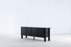 the sideboard is made from black wood and has three doors on one side, and four drawers on the other