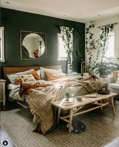 a bed room with a neatly made bed next to a chair and mirror on the wall