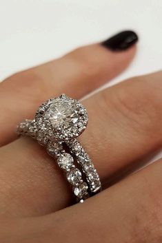 a woman's hand with a diamond ring on it