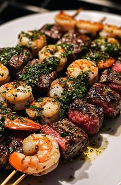 steak and shrimp skewers on a white plate