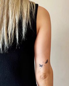 a woman with a small butterfly tattoo on her left upper arm and right lower arm