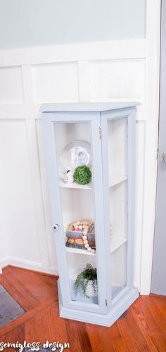 an empty glass cabinet in the corner of a room