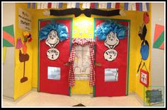 the dr seuss door is decorated with red and yellow doors, striped curtains, and cat in the hat decorations