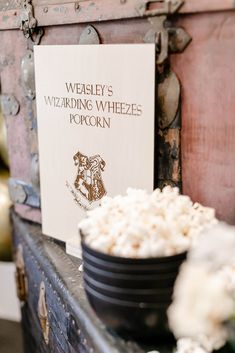 a wooden chest with a sign on it that says wedley's wedding wheezes popcorn