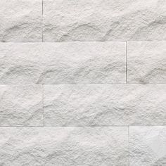 a white brick wall textured with cement