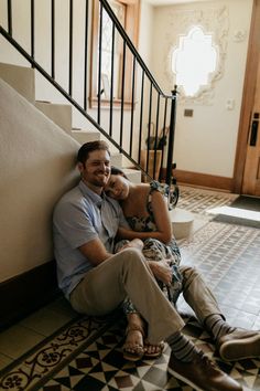 a man and woman sitting next to each other on the stairs