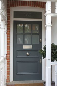 a gray front door with the words home & garden essentials on it's side