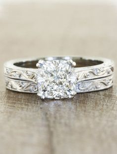 an antique style diamond engagement ring with filigrees