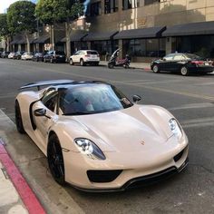 a white sports car is parked on the street