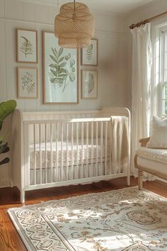 a white crib in a room with pictures on the wall and a rug underneath it