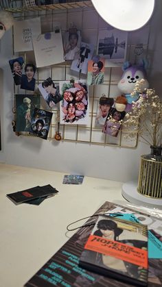 there are many pictures hanging on the wall in this office area, including posters and flowers