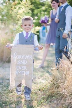 a little boy holding a sign with the words forever and ever around him on it