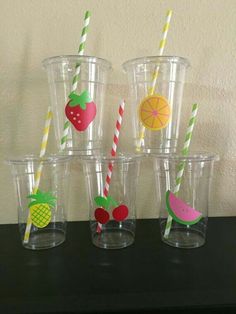 six plastic cups with straws and fruit on them