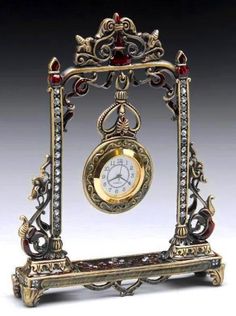 an ornate clock is sitting on a stand