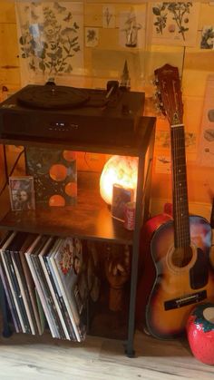 a small table with a guitar and record player on it