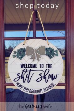 a welcome sign hanging from the front door