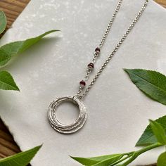 "This elegant necklace offers up a unique combination of playfulness & timeless style. Five organically shaped & uniquely textured sterling silver circles layer gracefully on a lovely sterling silver double cable chain. Each ring is handcrafted individually to represent your journey through the decades. Circles are hammered flat & strong, and given a rustic sparkly texture.  Three gemstones are intricately wrapped on the chain, creating a lovely birthstone accent. Choose from 15 gemstones! (Gems Adjustable Sterling Silver Birthstone Necklace With Round Pendant, Handmade Sterling Silver Birthstone Necklace For Birthday, Sterling Silver Birthstone Necklace With Round Pendant For Birthday, Luxury Sterling Silver Birthstone Necklace With Round Pendant, Gold-colored Sterling Silver Birthstone Necklace For Birthday, Birthday 5, Rings Necklace, Friend Jewelry, 5 Rings