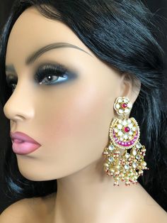 Beautiful and Unique Style Affordable Luxury traditional Bollywood Chandbali earrings with Kundan stones and Colored ruby semi precious Stones. 22k gold plated jewelry Length: 3.5 Inches Comes with push back closure Made in Brass with very high quality Kundan stones and Pearls. Lightweight Jewelry Click here to see the complete collection of Kundan and Polki Statement Earrings at AryaFashions: https://www.etsy.com/shop/AryaFashions?section_id=25872820 Follow us on social media for new and latest Kundan Chandbali, Ruby Bangles, Jewelry Kundan, Kundan Jewelry, Chandbali Earrings, Ruby Wedding, Light Weight Jewelry, Earrings Indian, Kundan Earrings