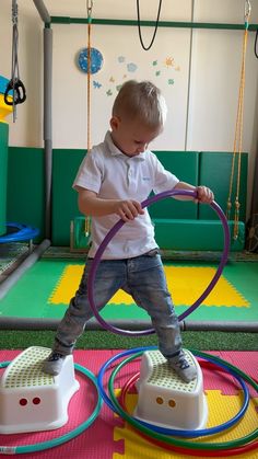 a little boy playing with some kind of toy