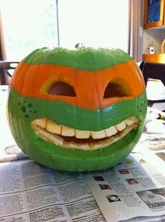 an image of a pumpkin carved to look like a frog's face with teeth