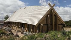 a wooden building with a cross on the roof