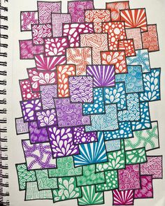 a spiral notebook with many different colored squares on it, all lined up in the same pattern