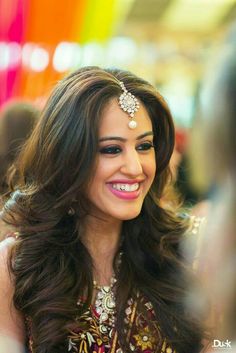 a woman with long hair smiling and wearing a headband on her head, in an instagram