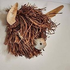 an animal made out of twigs and wooden spoons