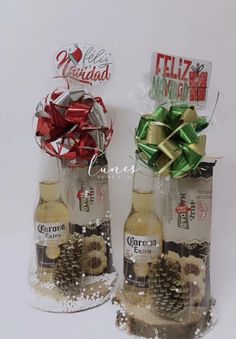 two wine bottles with christmas decorations in them