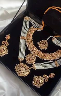 A versatile set encrusted with zircon stones and pearl moti. The set includes a pair of beautiful earrings, tikah and mala and rani haar.  Gold-plated on high-quality brass as base metal.  Approximate earrings length is 3.5″.