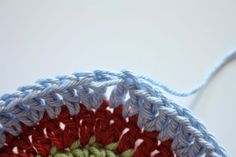 a crocheted object is shown on the table with a white cord attached to it