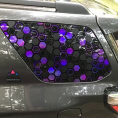 a car with purple and black hexagonal design on it's side window