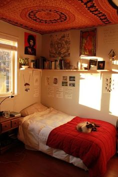 a bed room with a neatly made bed and a cat laying on top of it