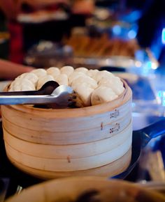 a wooden container filled with food on top of a table