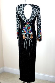 "Amazing gown! This is absolutely beautifully beaded, with an amazing back, a beautiful top and in Excellent condition!! Form fitted, with fabulous split in the middle Measures:55\" length Bust: 34\"+ Waist: 26\" Hip: 34\" Sleeves: 23\" Pet Free/smoke free Enjoy!" Hand Embellished Fitted Maxi Evening Dress, Fitted Hand Embellished Maxi Evening Dress, Fitted Beaded Evening Gown, Fitted Beaded Gown For Evening, Beaded Fitted Evening Gown, Fitted Floor-length Embellished Dresses, Fitted Embroidered Dress With Geometric Embroidery And Long Sleeves, Long Sleeve Embroidered Dress With Geometric Embroidery, Luxury Embroidered Dress With Geometric Design