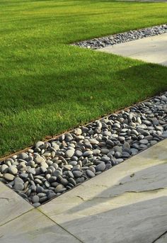 some rocks and grass in the middle of a walkway