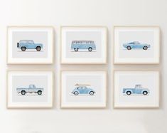 four blue cars are mounted on the wall above a white table and chairs in front of them