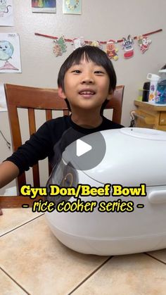 a little boy sitting at a table with a big bowl on it