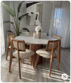 a dining room table with four chairs around it