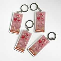 three keychains that have been designed to look like the same card as each other