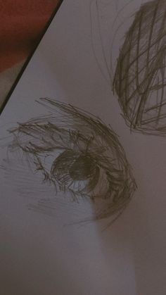 two drawings of eyes are shown on a piece of paper