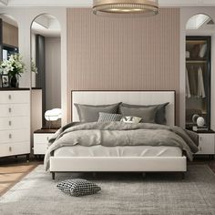 a bedroom with a bed, dressers and mirror in it's center area